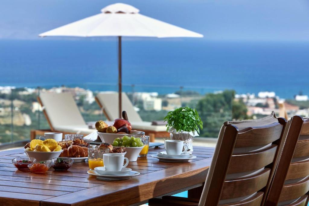 a wooden table with food on top of a balcony at Cottage Kokkini Hani in Kokkini Khanion