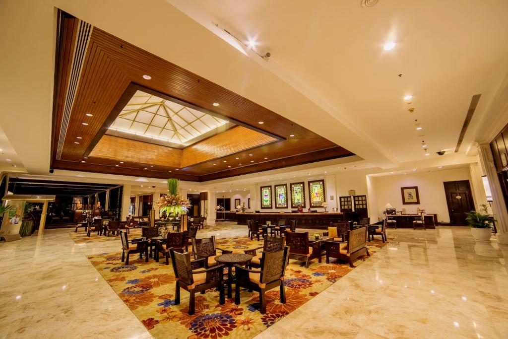 a dining room with tables and chairs and a skylight at Waterfront Airport Hotel and Casino in Mactan