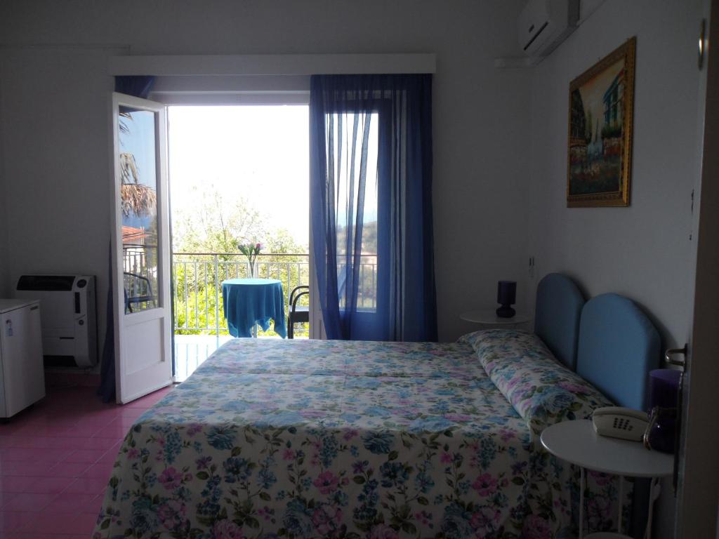 Postel nebo postele na pokoji v ubytování Hotel Villa Degli Aranci