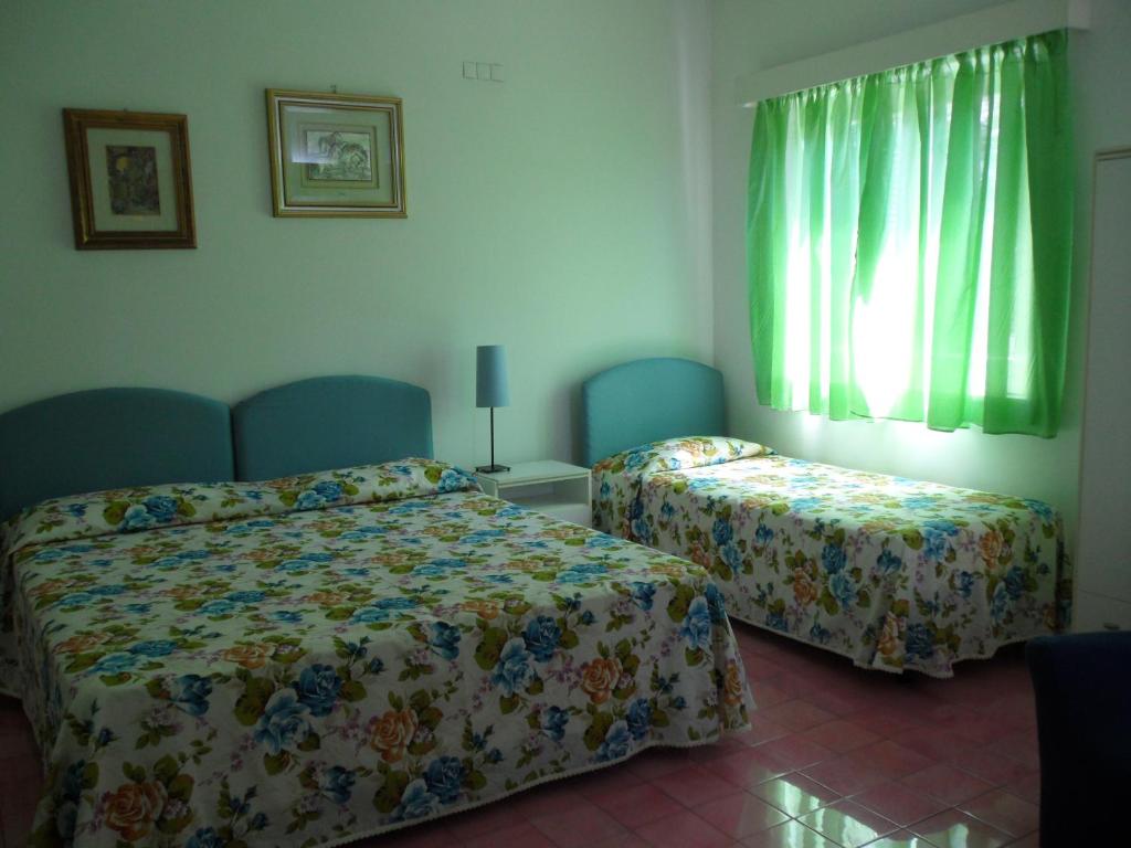 Postel nebo postele na pokoji v ubytování Hotel Villa Degli Aranci