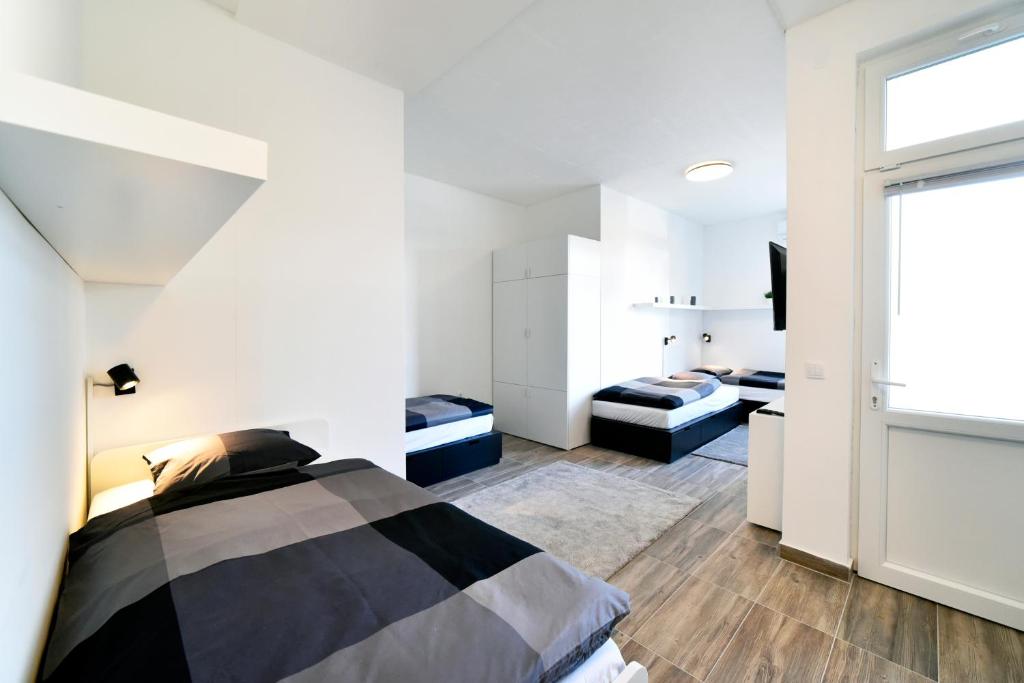 a bedroom with a bed and a large window at Apartments Dubec in Sesvete