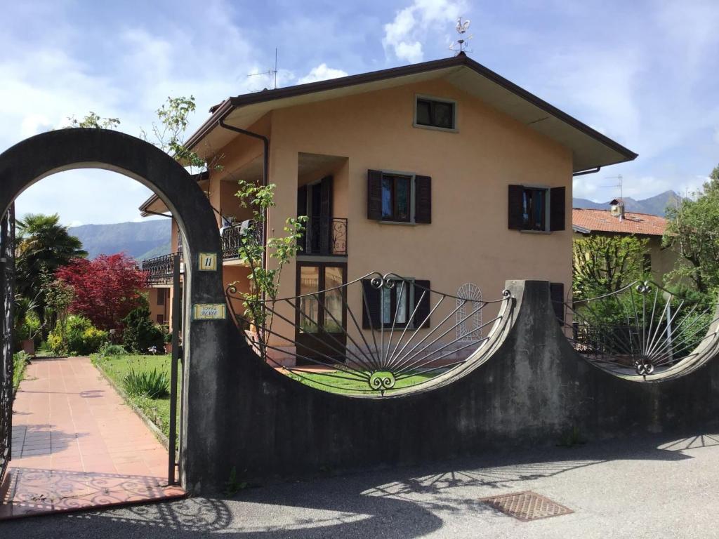 a house with an archway in front of a house at Villa Romeo - Acero Rosso in Rovetta
