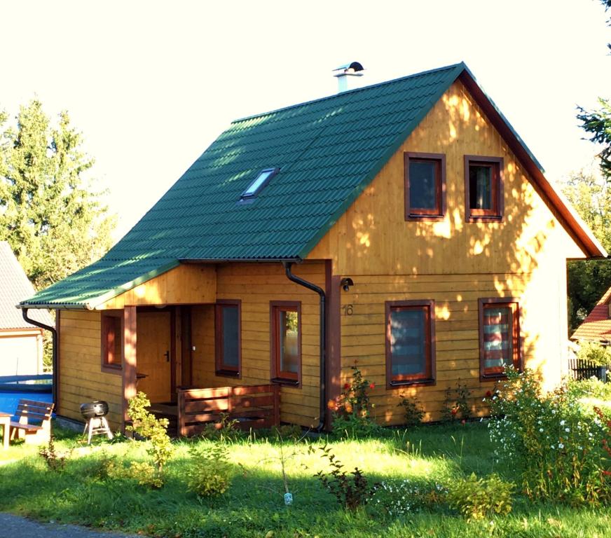 una pequeña casa de madera con techo verde en Chata Thurmberg, en Vyšší Brod