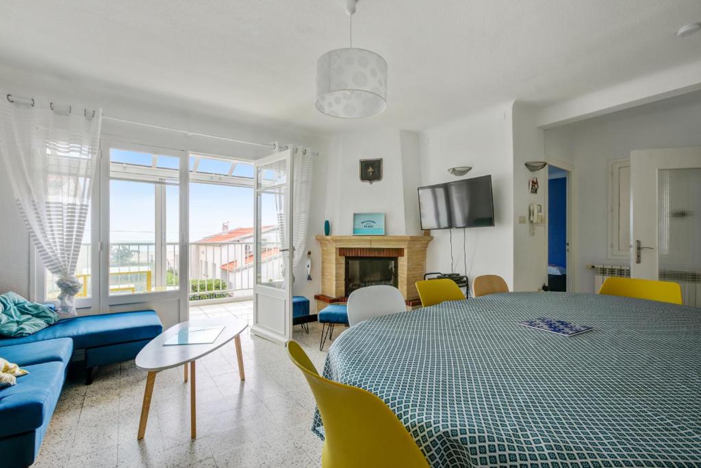 a living room with a table and a couch at Maison de vacances avec jardin à 50 m de la plage in Narbonne