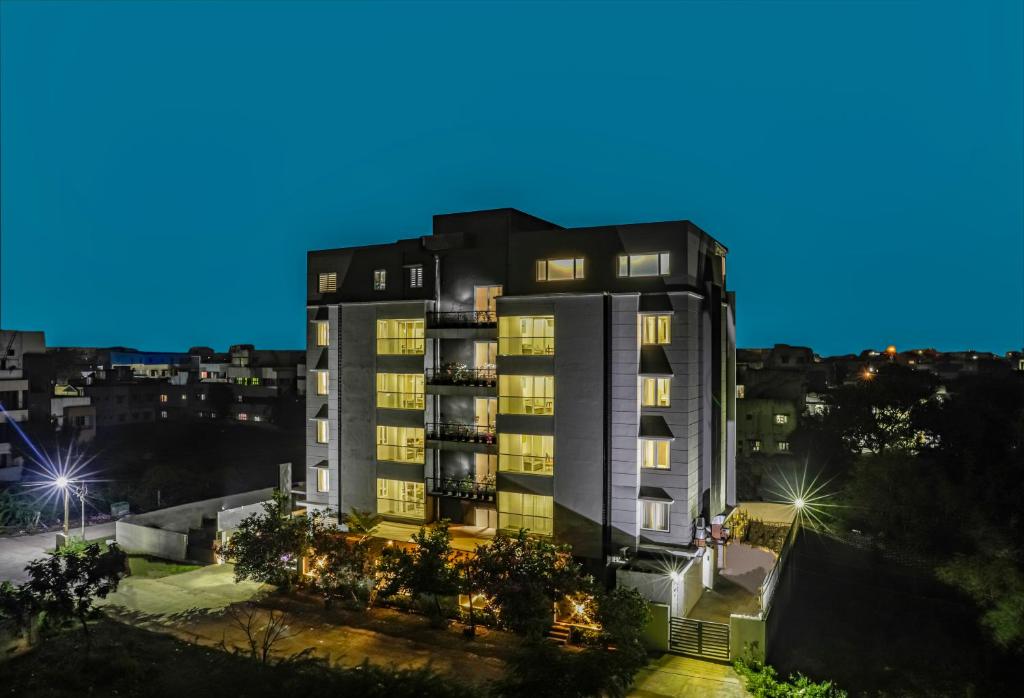 a tall apartment building at night in a city at Floressa Randa, Porur in Chennai