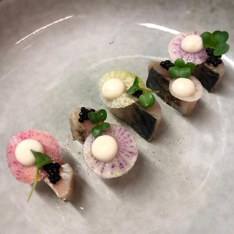 a plate with four different types of desserts on it at Domaine Saint Clair - Le Donjon in Étretat