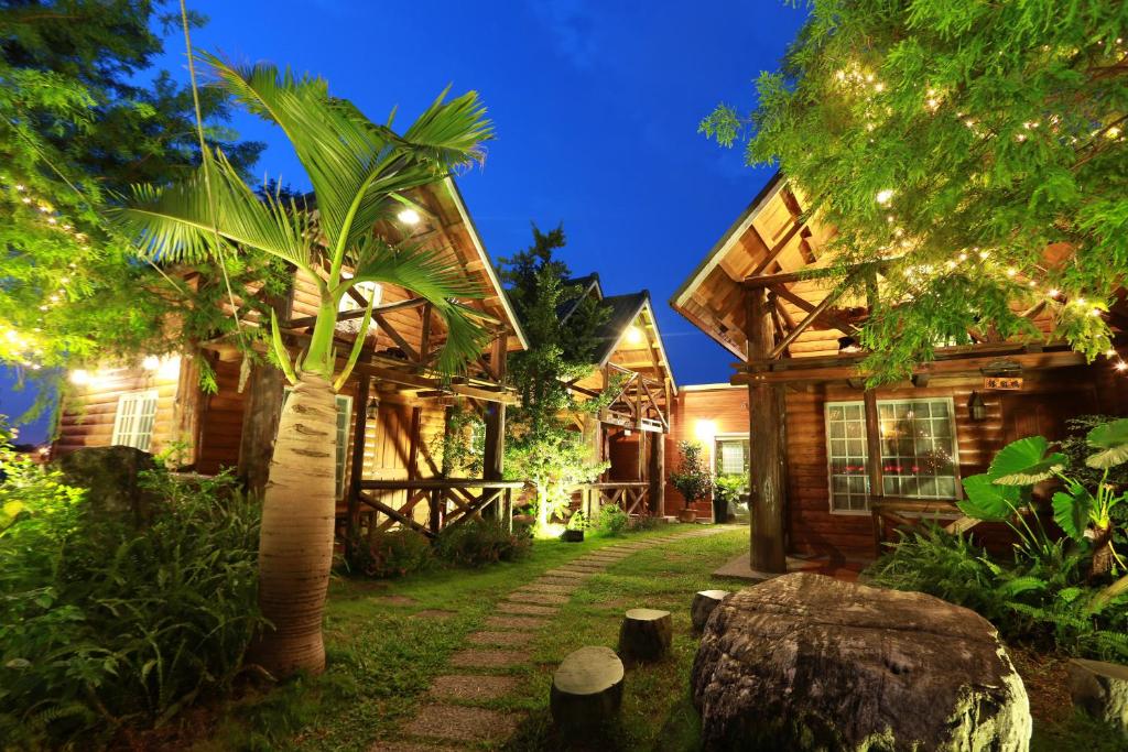 a log house with a pathway leading to it at Dongshan River Resort Farm in Wujie