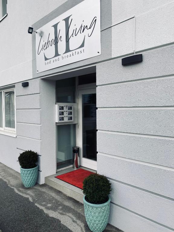 a front door of a building with a red carpet at Lieboch Living in Lieboch