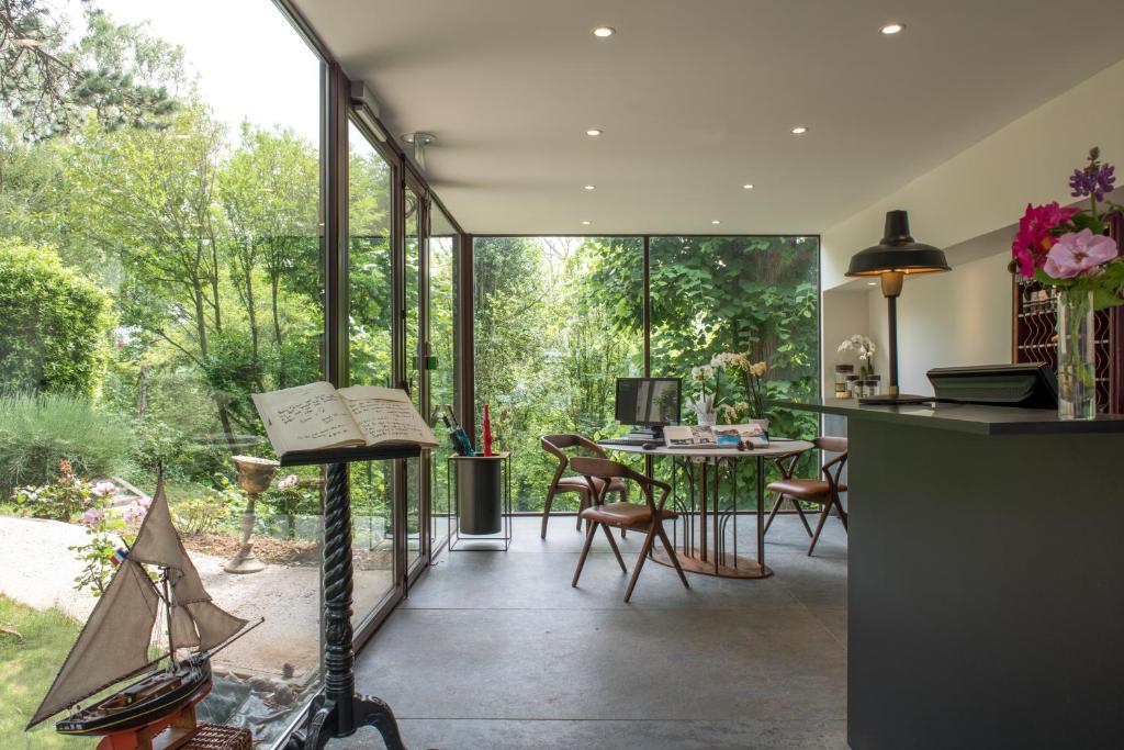 a kitchen and dining room with a large glass window at Domaine Saint Clair - Le Donjon in Étretat