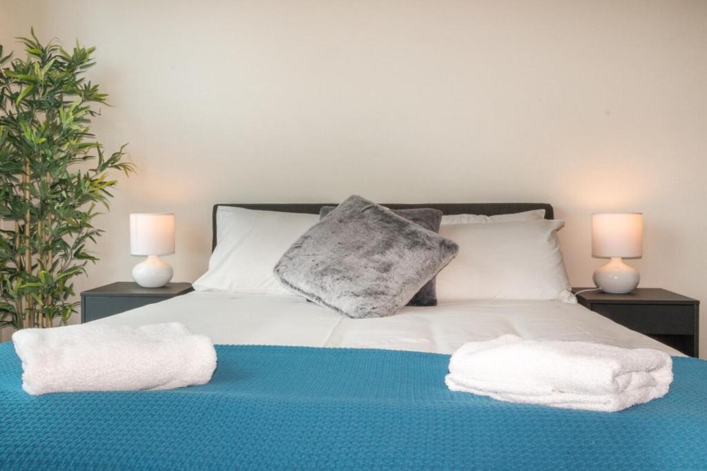 a bedroom with a bed with towels on it at 1 Bed Studio Apartment Near Eagle Street in Brisbane