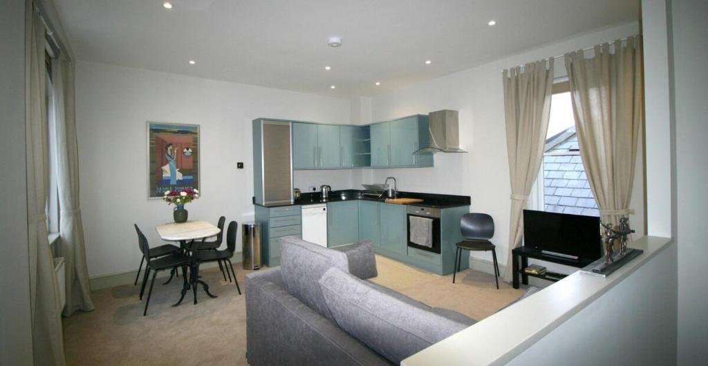 sala de estar con sofá y cocina en Stylish light-filled 1 Bedroom Flat In Hammersmith en Londres
