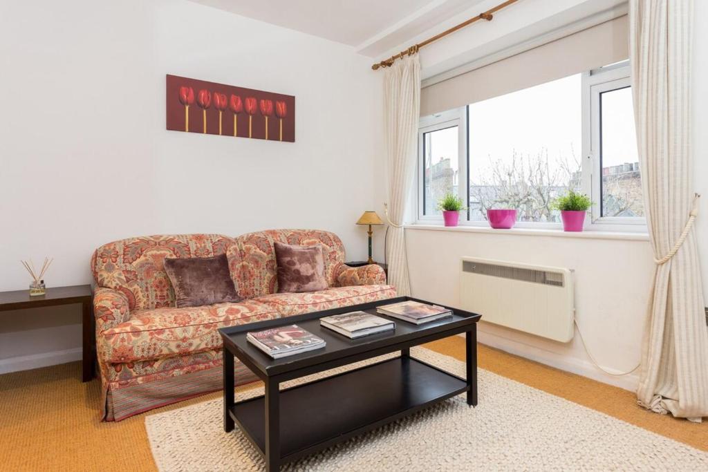 sala de estar con sofá y mesa en Professionally Cleaned 1 Bed flat in South Kensington, en Londres