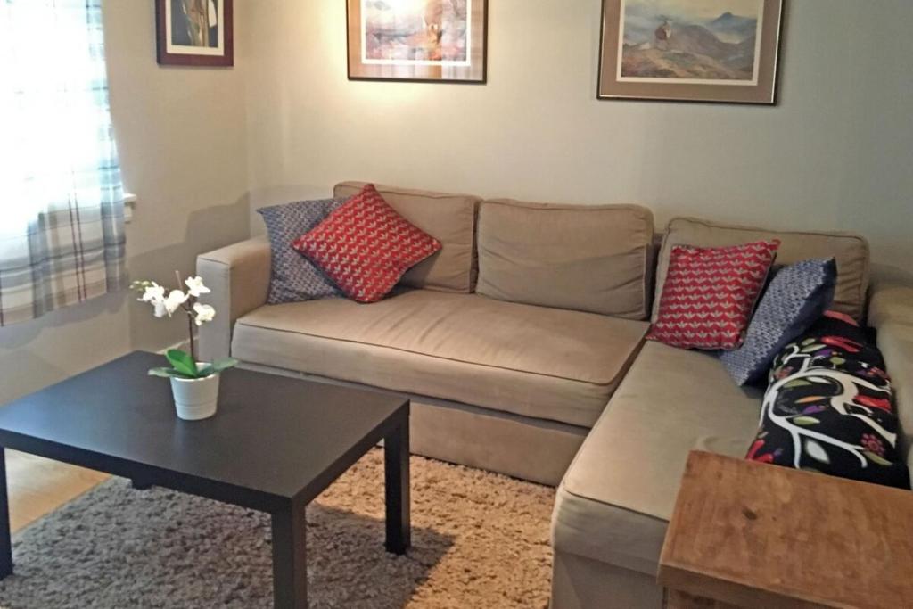 a living room with a couch and a table at Bright Spacious 2 Bedroom Apartment in Stockbridge in Edinburgh