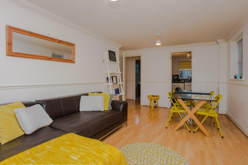a living room with a couch and a table at Contemporary 1Bedroom Flat in Camberwell Oval in London