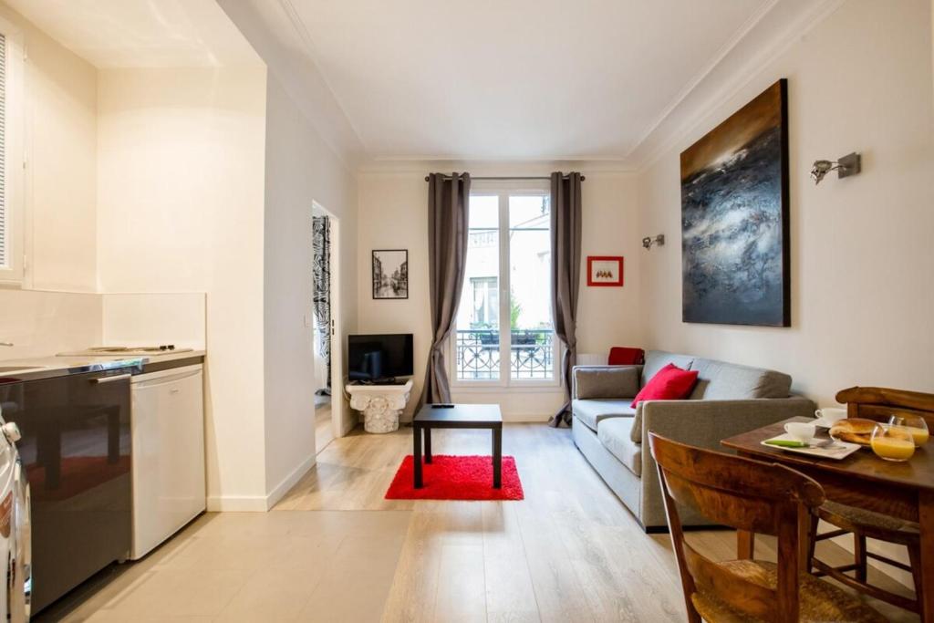 sala de estar con sofá y mesa en Modern arty flat close to Saint-Germain des Près, en París