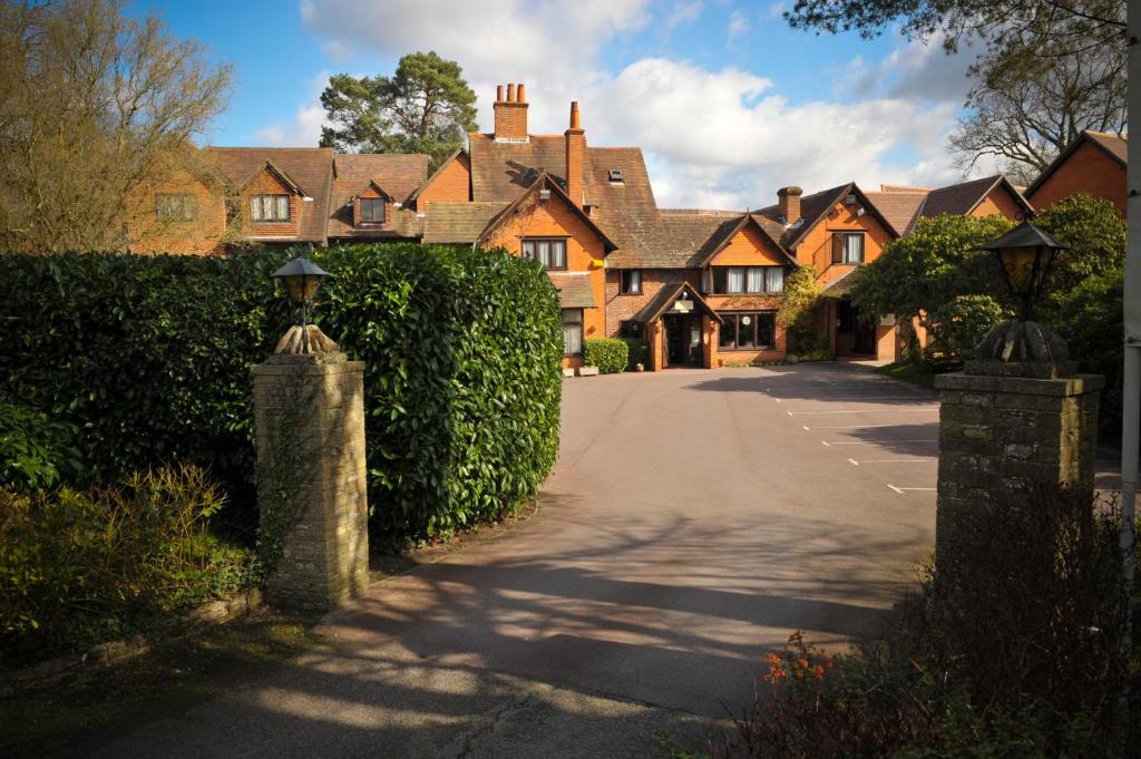 a large house with a driveway in front of it at The Casa Hotel-Yateley, Farnborough in Yateley
