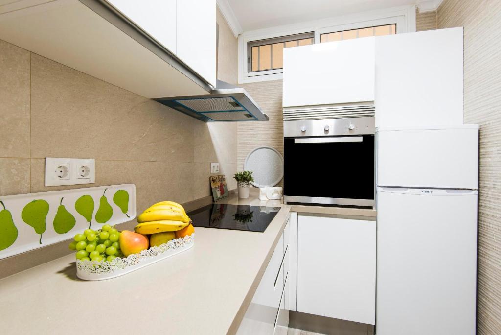 A kitchen or kitchenette at Beachfront apartment Puerto Marina