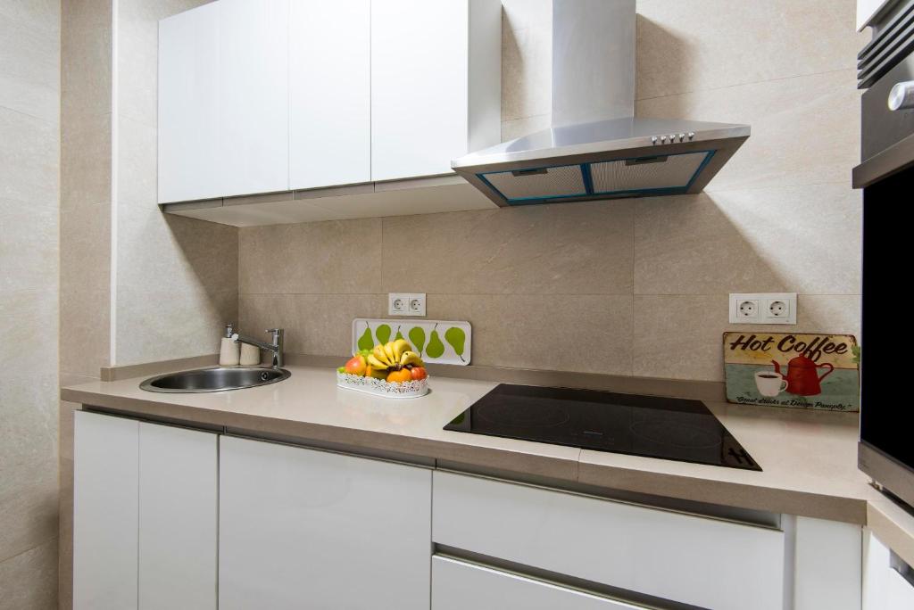A kitchen or kitchenette at Beachfront apartment Puerto Marina