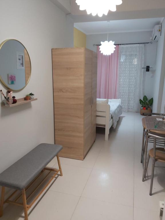 a living room with a table and a mirror at Konstantina's studio near the beach in Chania Town