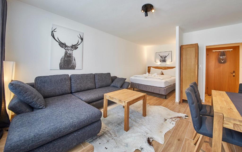 a living room with a couch and a bed at Appartement Timeout in Saalbach-Hinterglemm