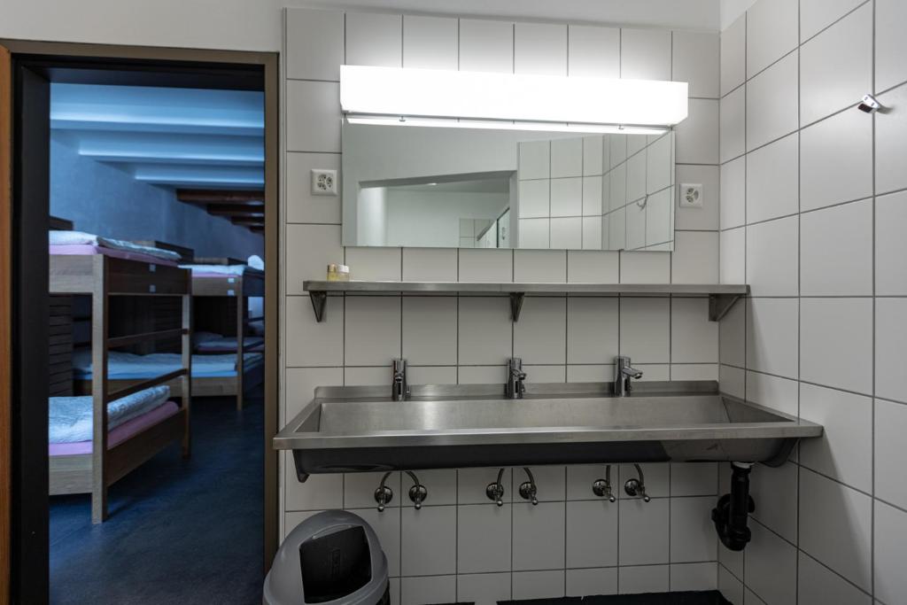 a bathroom with a sink and a mirror at Hotel Restaurant Stockalperturm in Ruden