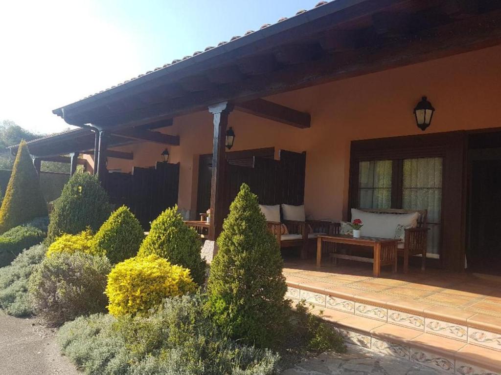 un porche de una casa con terraza de madera en Apartamentos El Pedrayu, en Onís