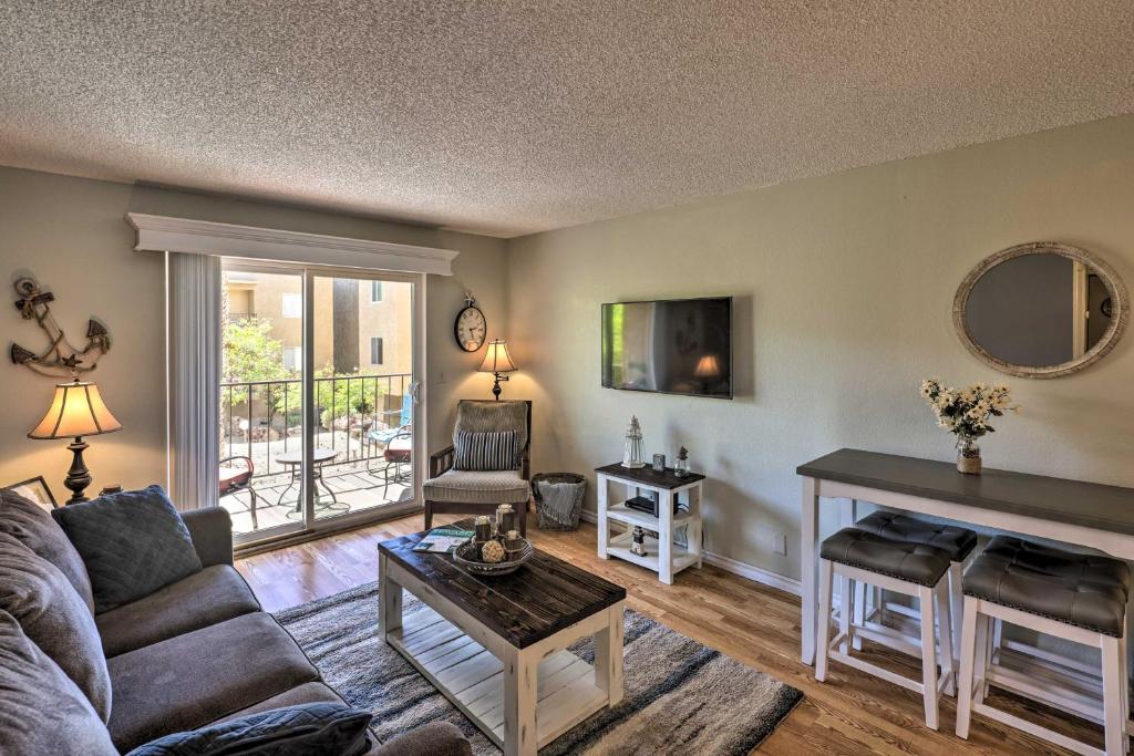 a living room with a couch and a table at Condo with Balcony - Walk to Lake, Dining, and Shops! in Lake Havasu City