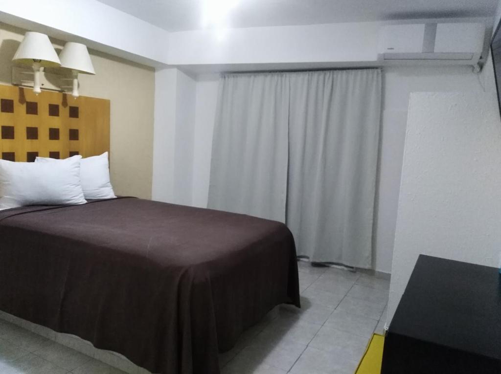 Postel nebo postele na pokoji v ubytování Hotel Posada del Carmen