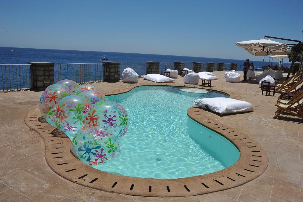 a swimming pool with balloons in the water at Diva La Canzone Del Mare in Capri