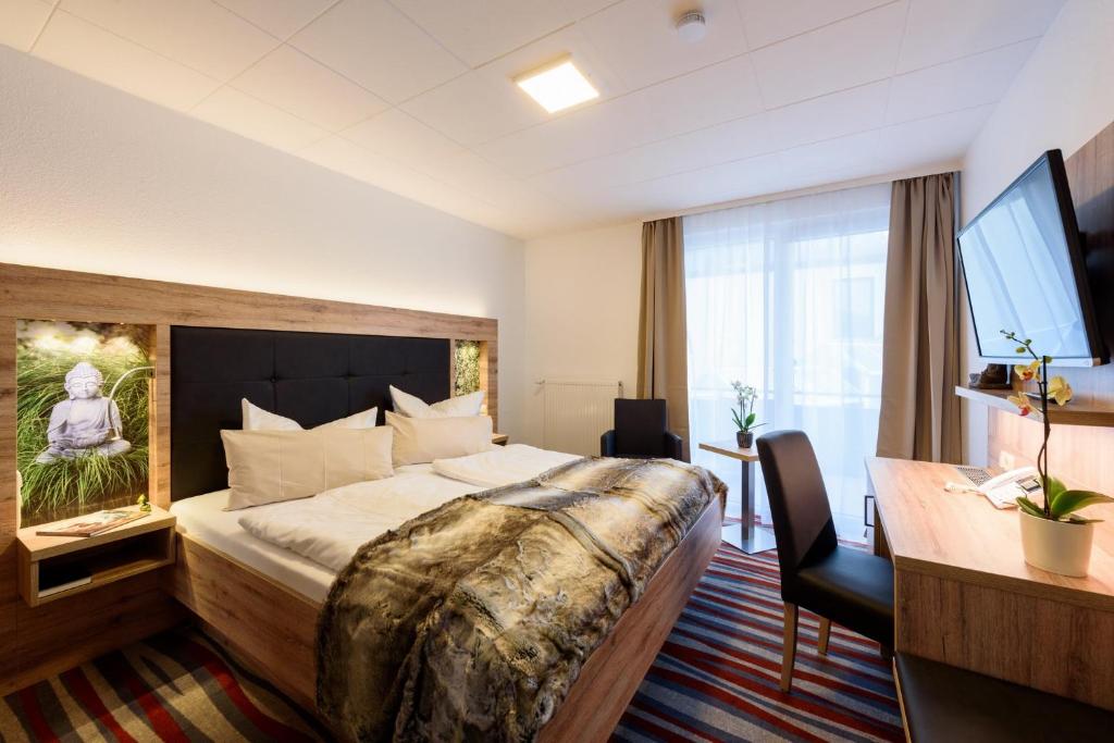 Postel nebo postele na pokoji v ubytování Wellness & Ayurveda Hotel Am Eichenberg