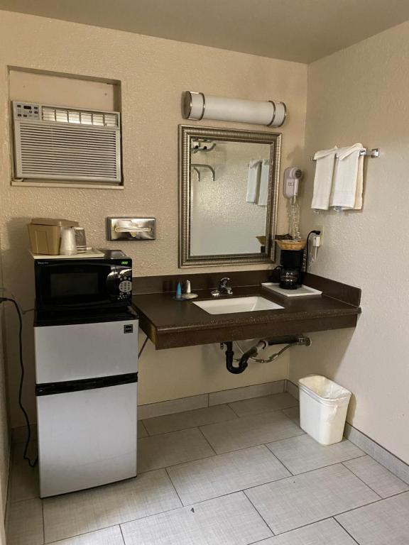 a bathroom with a sink and a mirror at Motel In The Pines in Munds Park