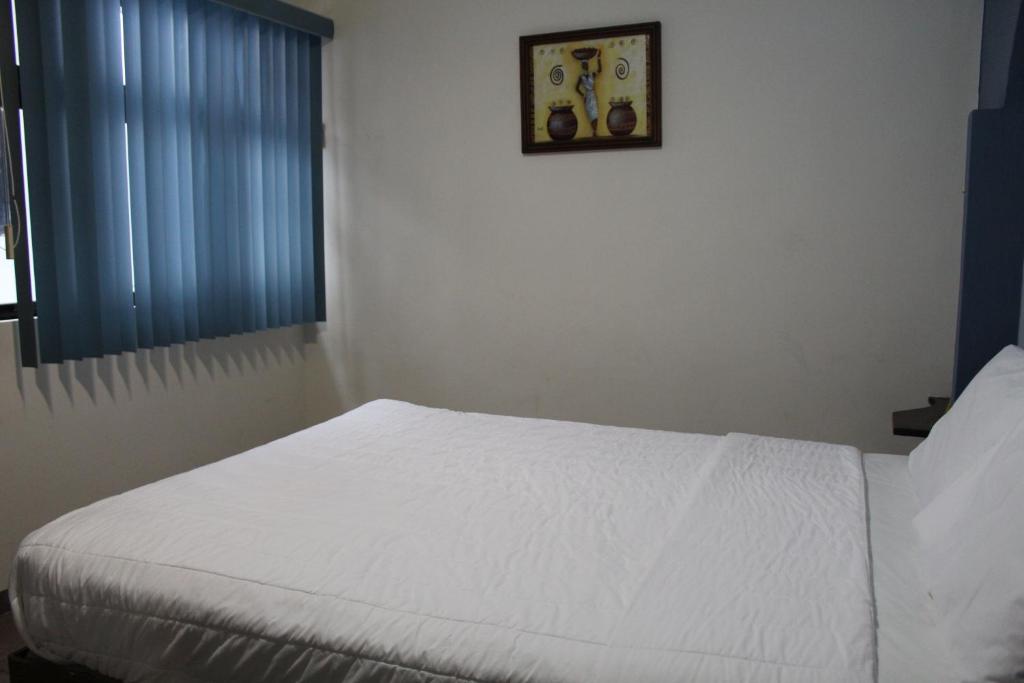 Postel nebo postele na pokoji v ubytování Invernadero Inn
