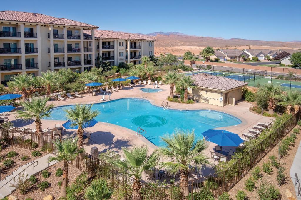 an aerial view of a resort with a pool and palm trees at WorldMark Estancia in St. George