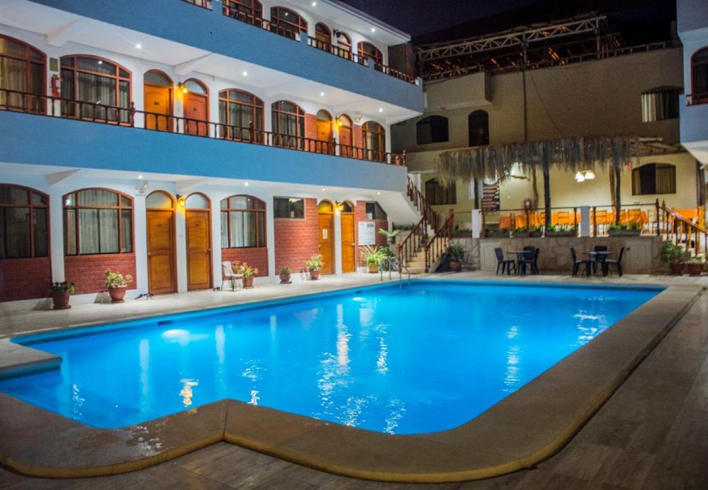 a large swimming pool in the middle of a building at Hotel Curasi in Ica