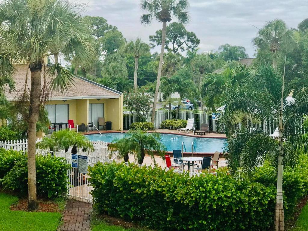 a pool at a resort with palm trees at Spacious Condo close to Siesta in Sarasota