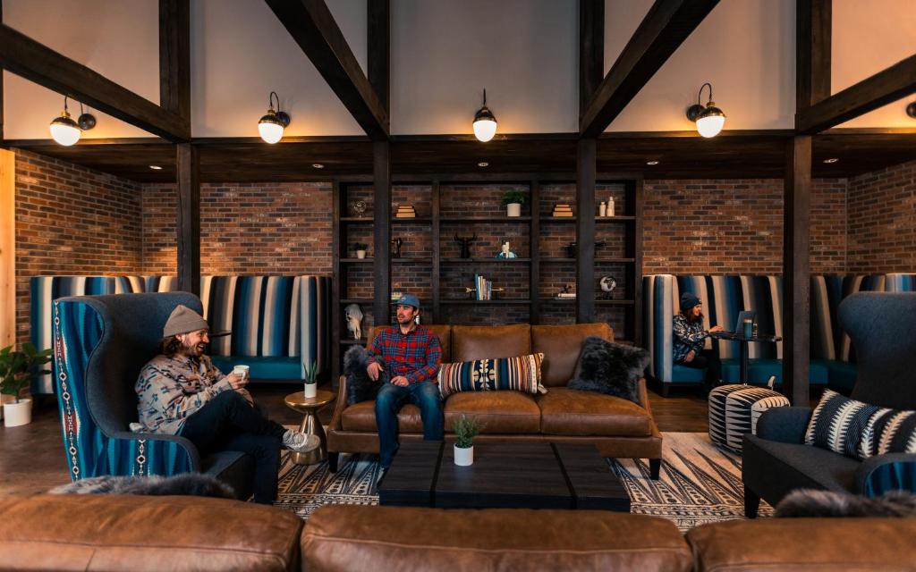 two people sitting in chairs in a living room at The Bivvi Hostel Telluride in Telluride