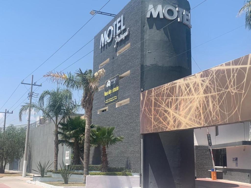 a building with a sign on the side of it at Motel Pedregal Suites in San Juan del Río