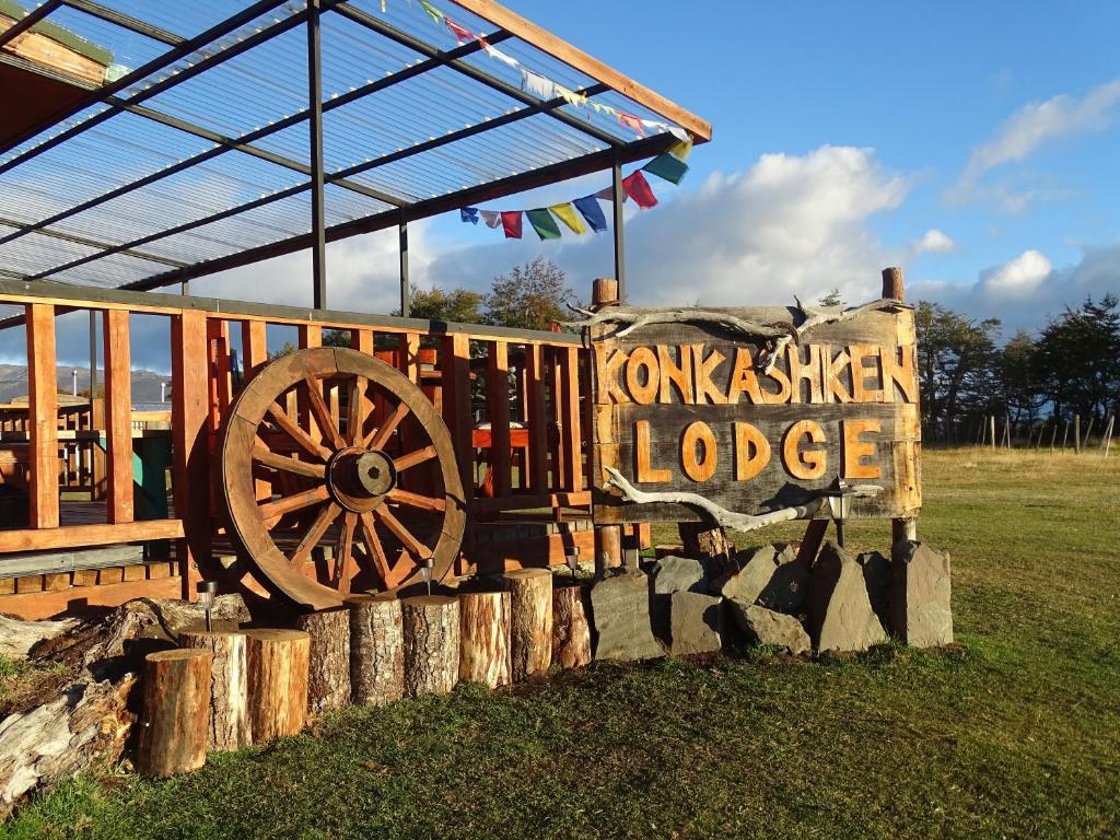 a wooden wagon on display in a field at Konkashken Lodge in Torres del Paine