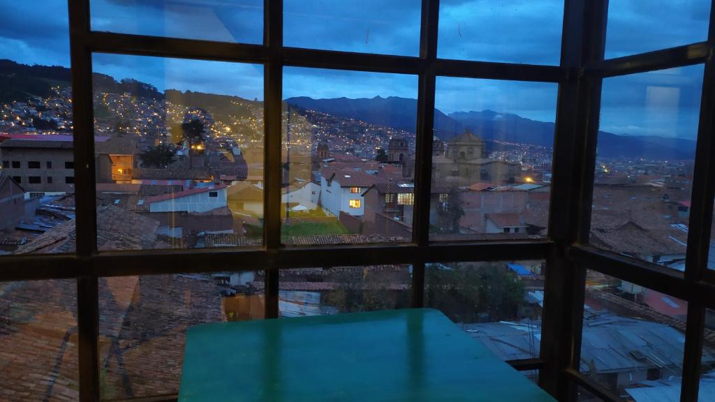 a view of a city from a window at The Chusay Rooftop in Cusco