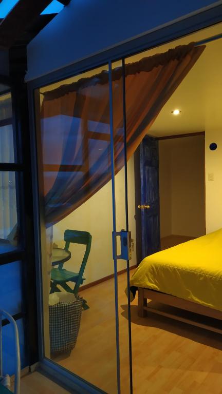 a bedroom with a bed and a window at The Chusay Rooftop in Cusco