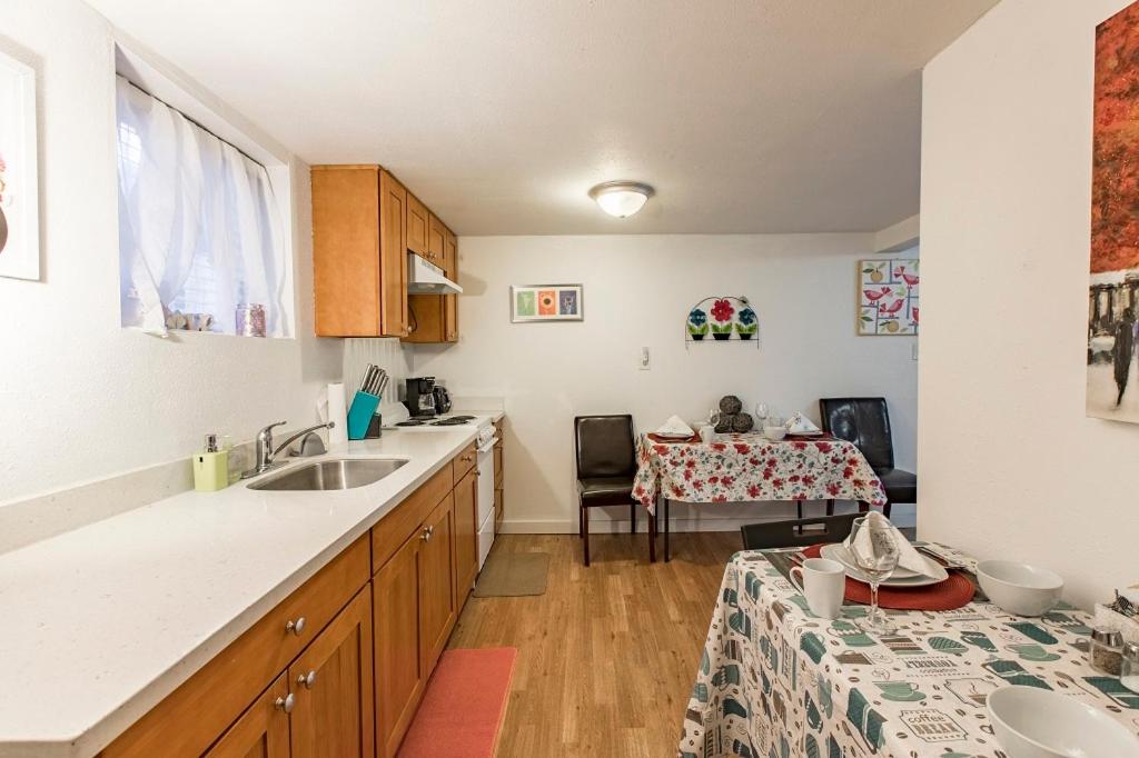 a kitchen with a sink and a table at Seattle Urban Village- Unit B- Lago Vista- Lake Union- Sleeps 6 in Seattle