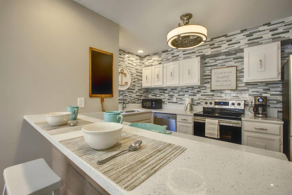 a kitchen with a counter with bowls on it at Bay Oaks C 2nd Floor in Siesta Key