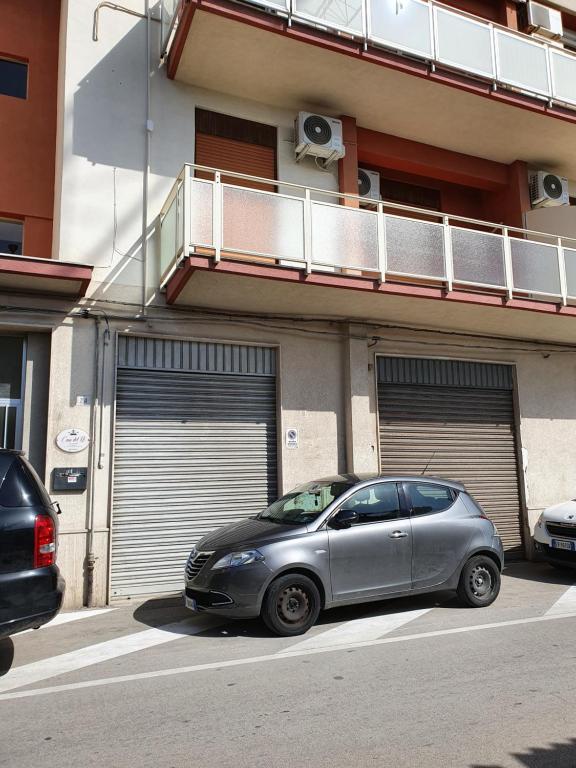 a silver car parked in front of two garage doors at Casa del re in Licata