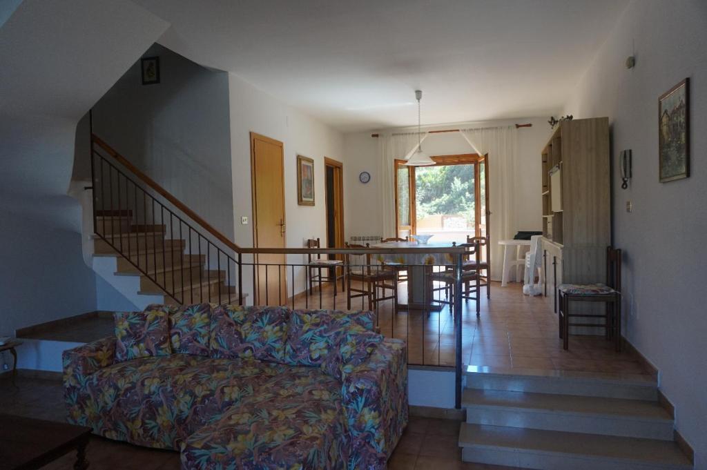 a living room with a couch and a dining room at Casa Adriana in Alghero