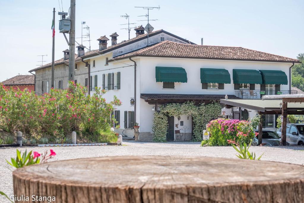 a large white building with green awnings on it at Cascina Graziosa in Lonato