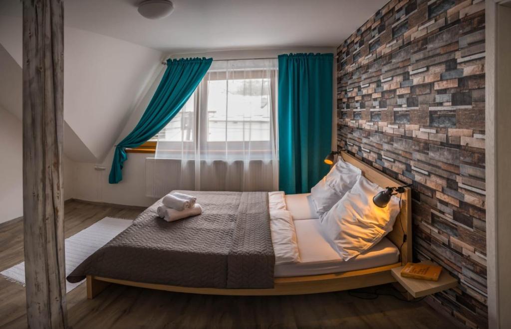 Postel nebo postele na pokoji v ubytování Apartmány Habovka