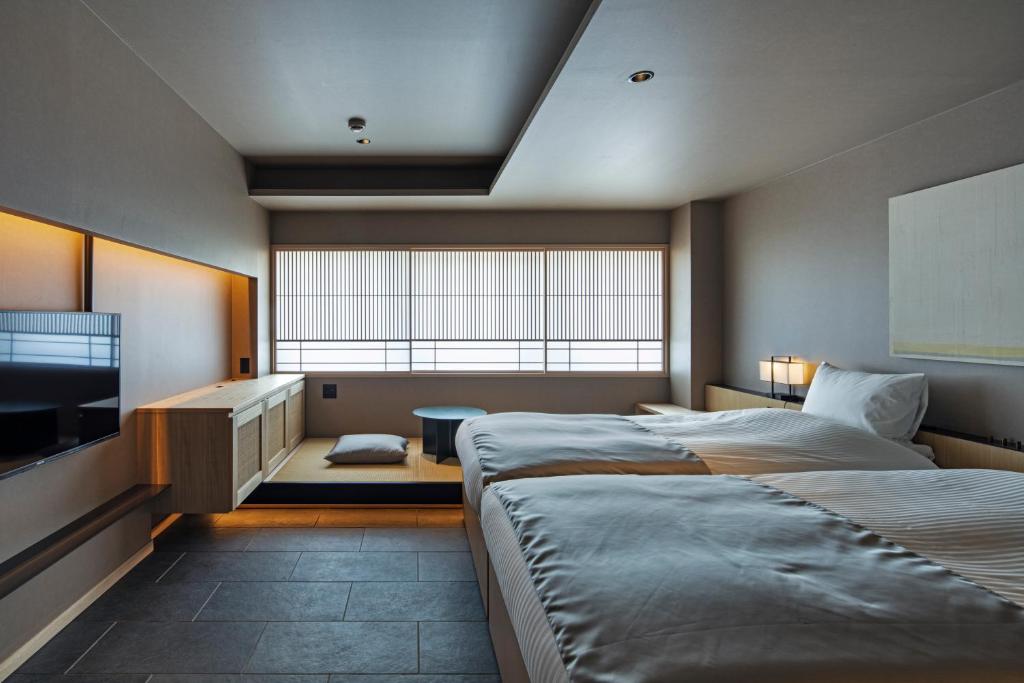 Postel nebo postele na pokoji v ubytování hotel tou nishinotoin kyoto