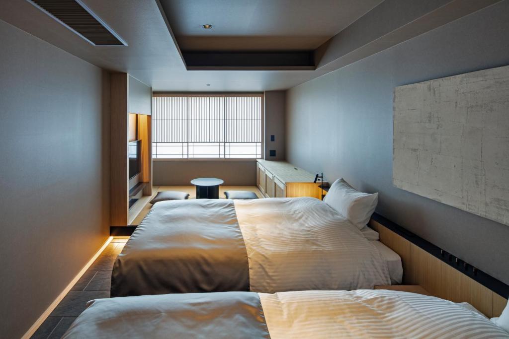 Postel nebo postele na pokoji v ubytování hotel tou nishinotoin kyoto