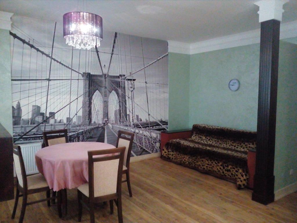 a dining room with a table and a bridge at Бруклінський міст.Студія в центрі. in Ivano-Frankivsʼk
