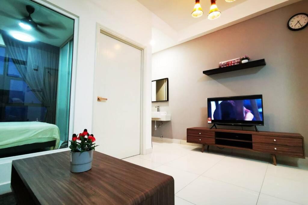 a living room with a television and a coffee table at HappyHome @ Arte Mont Kiara Kuala Lumpur Hartamas Damansara in Kuala Lumpur